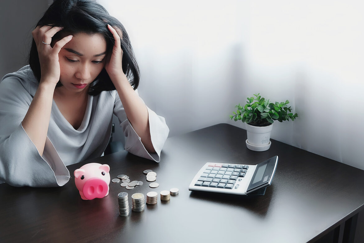 stressed-businesswoman-working-while-sitting-table